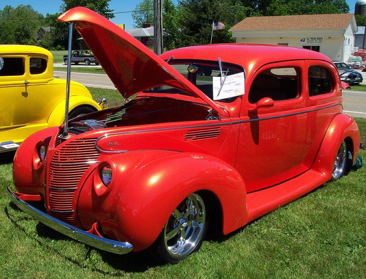 classic cars parked in a row on the grass