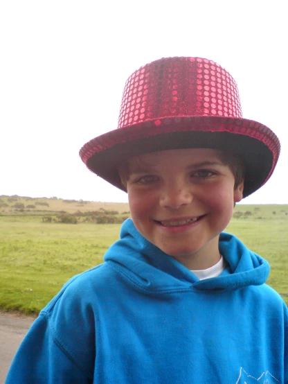 a child in a blue hoodie and red hat