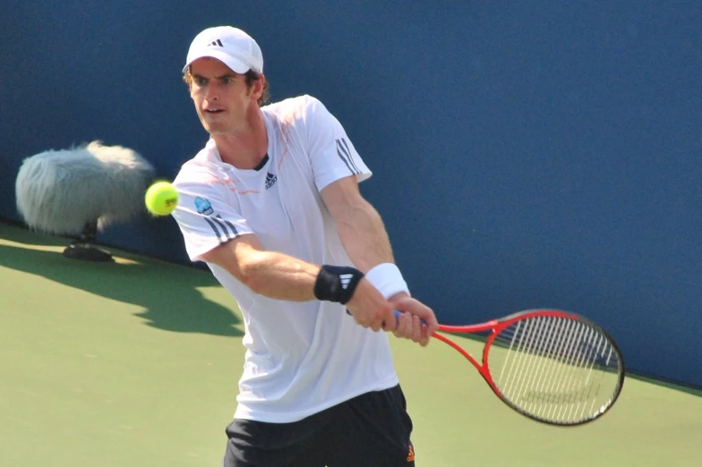 tennis player with racket and ball near wall