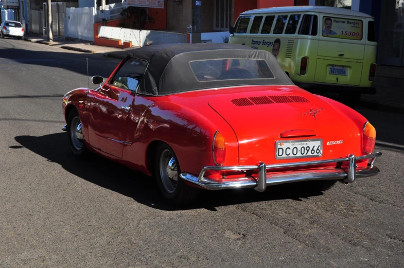 an old car is parked on the side of the street