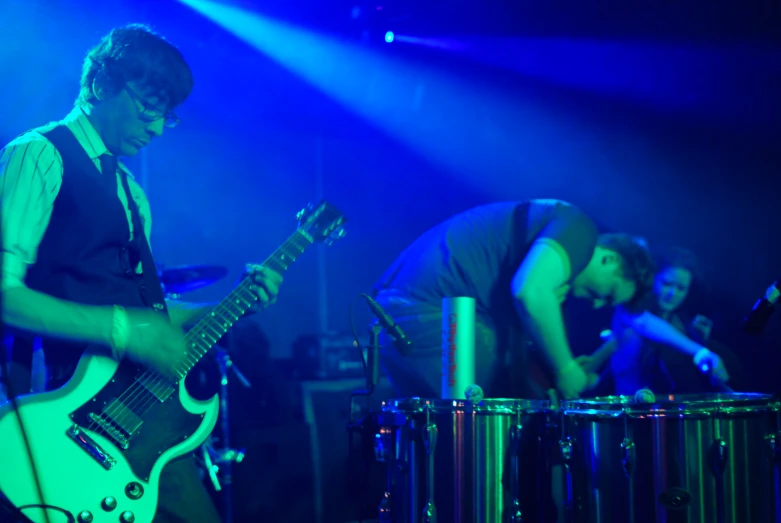 a group of guys with guitars on stage