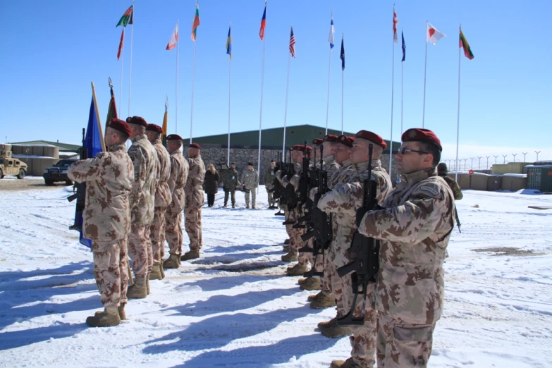 a group of soldiers saluting the colors during a ceremony