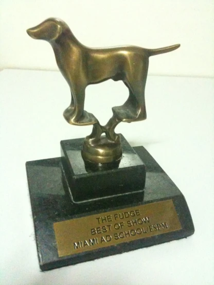 a golden statue of a dog is displayed