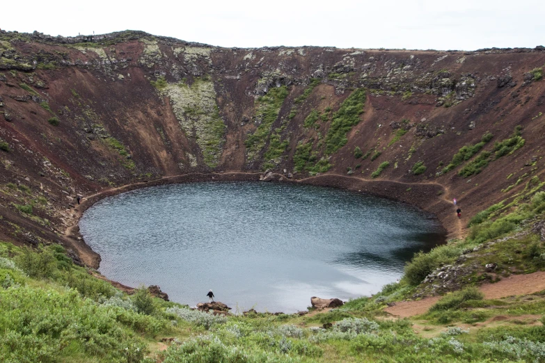 the view of a large pool of water in an area with low cliffs