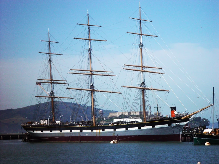 a ship floating on the water next to land