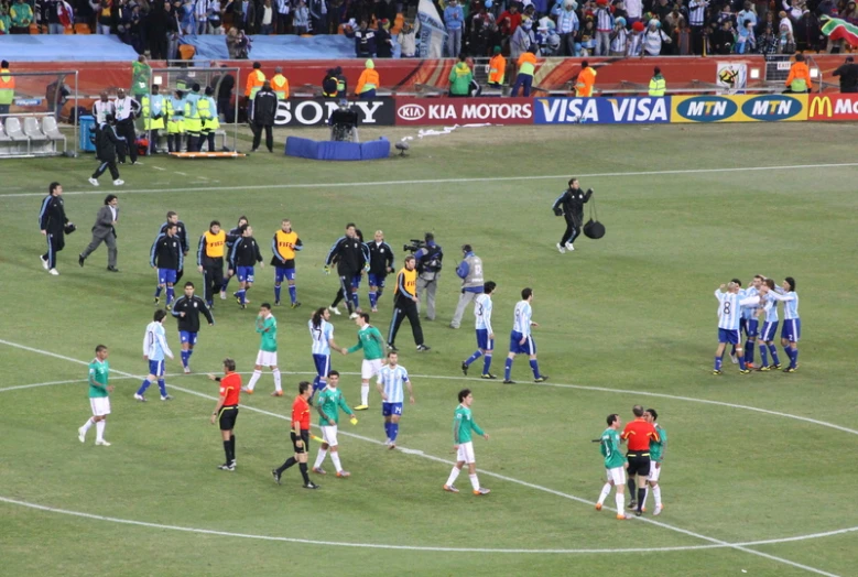 a group of soccer players standing on a field