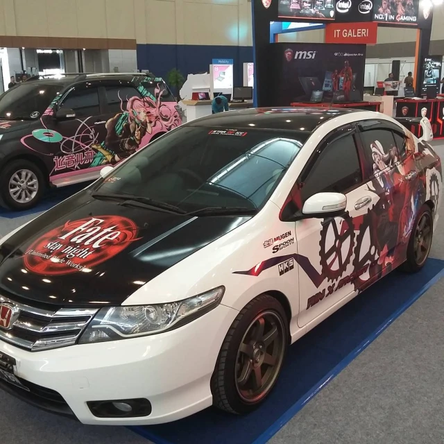 two cars are shown in the showroom for sale