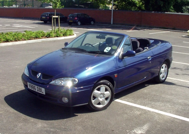 a car parked in a parking lot, with a person sitting in the top car