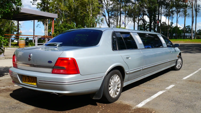 a silver car in a parking lot on a sunny day