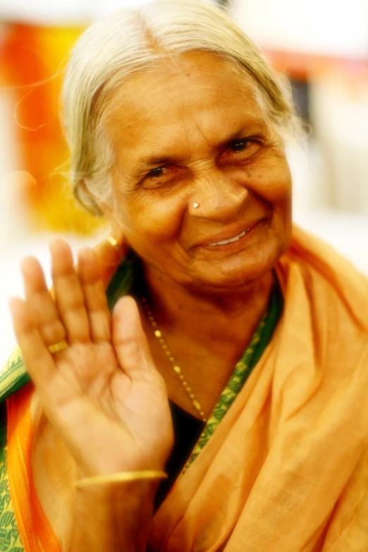 an old woman posing with her hand in her air