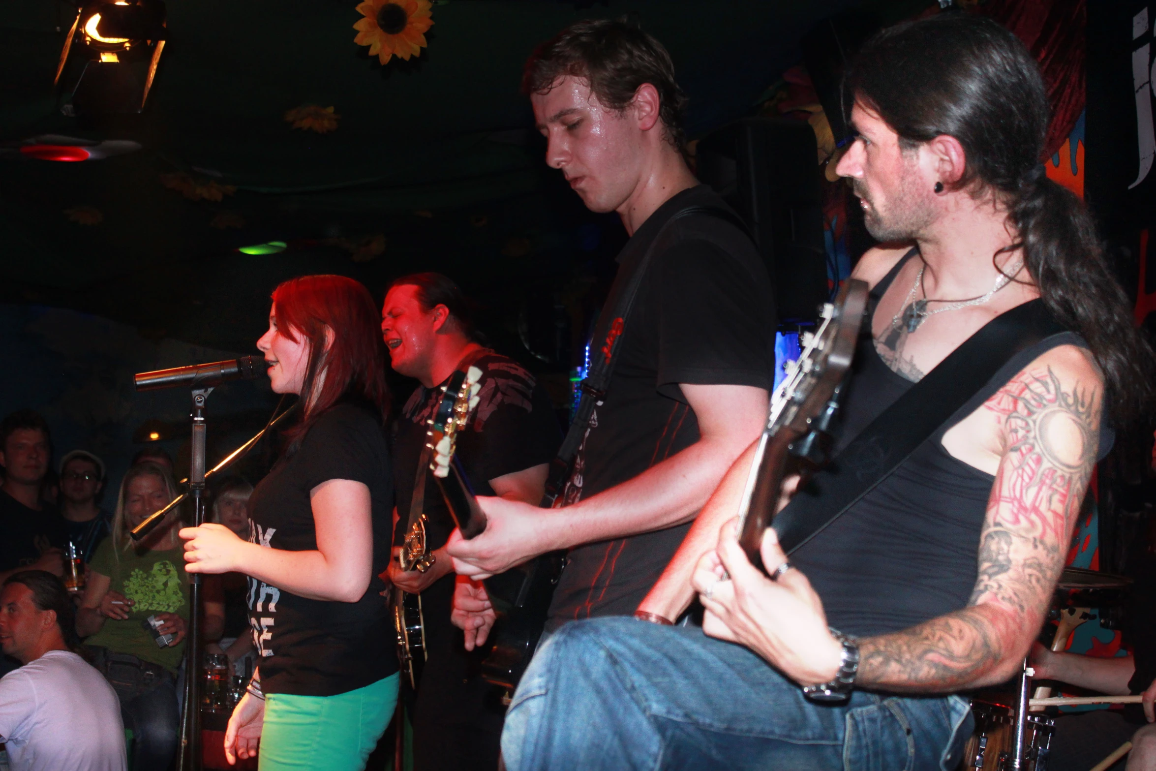 a group of young men playing guitars in a room