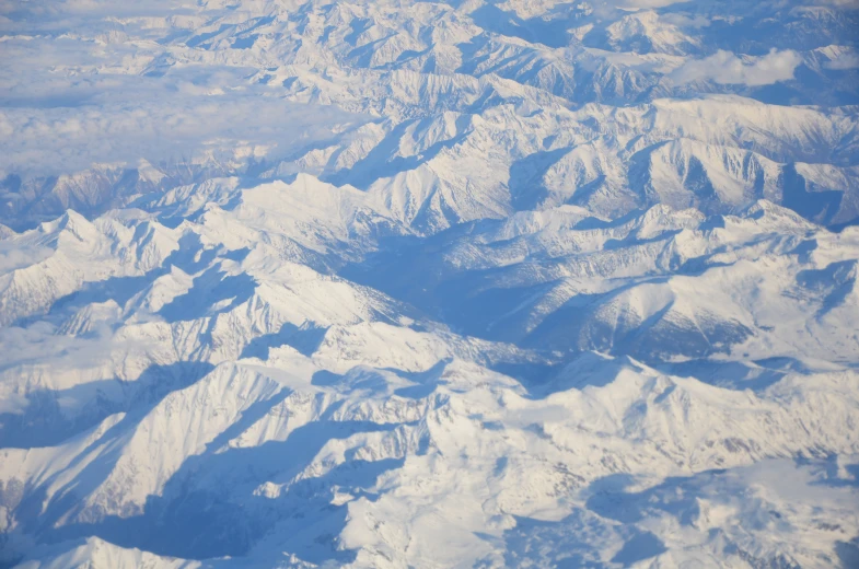 an aerial view of the mountains and clouds