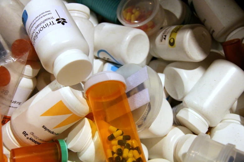 an array of pills being held and pographed by someone's hand