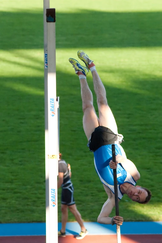 a man is doing aerial acrobatic tricks on the side walk