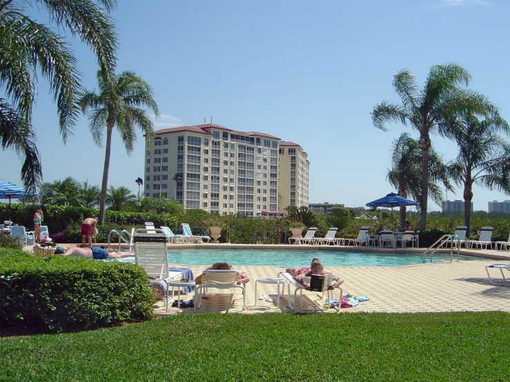 a man lounging near the pool of a el