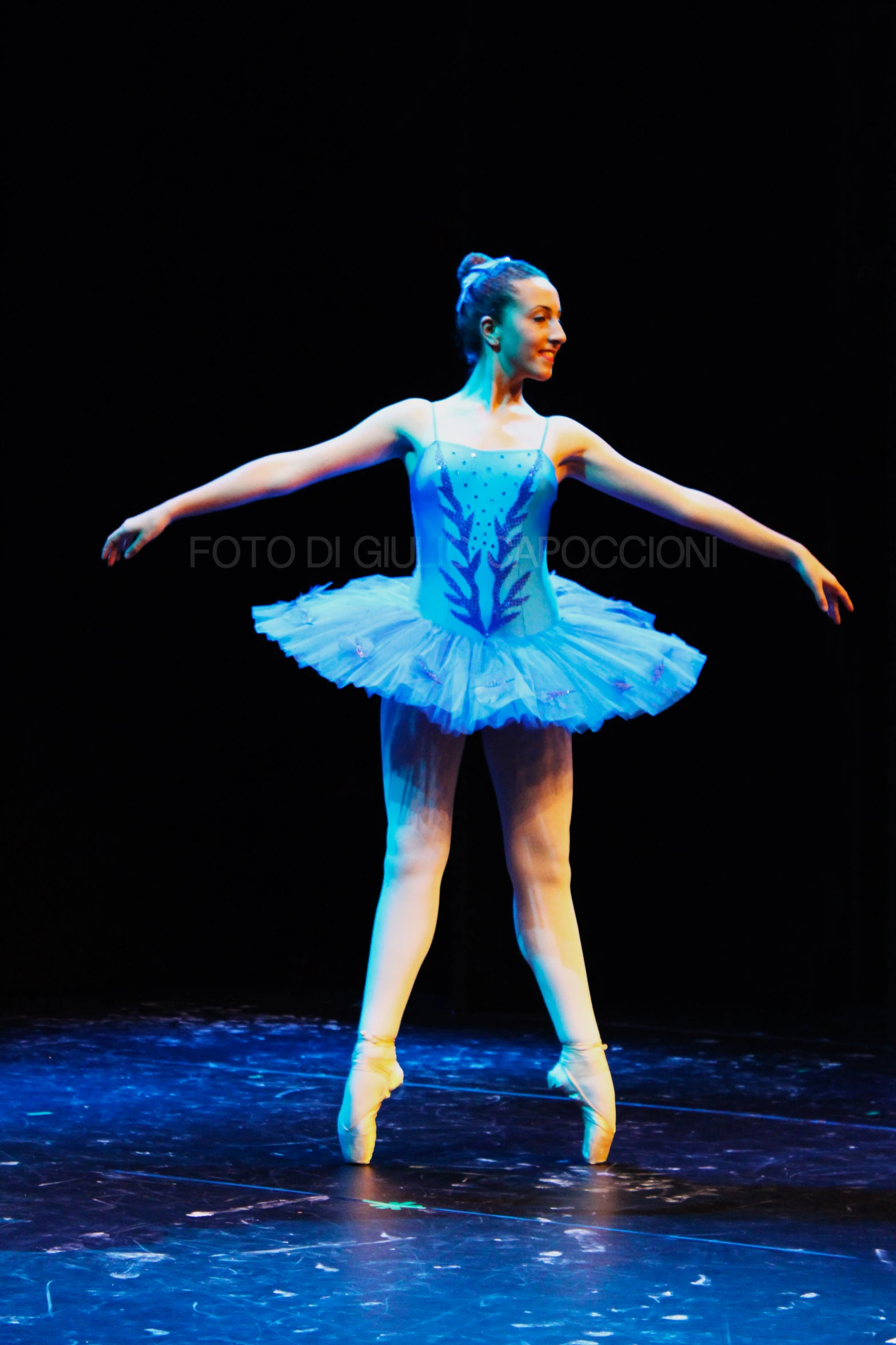 a young ballerina wearing a light blue tutu