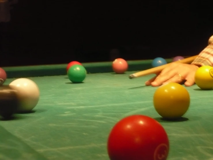 a person throwing a billiard's cue into the pool