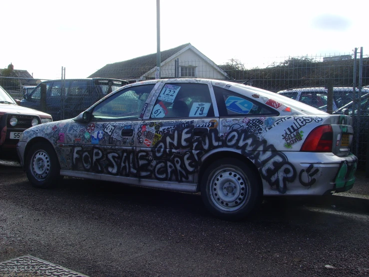 an image of a car painted with stickers and graffiti