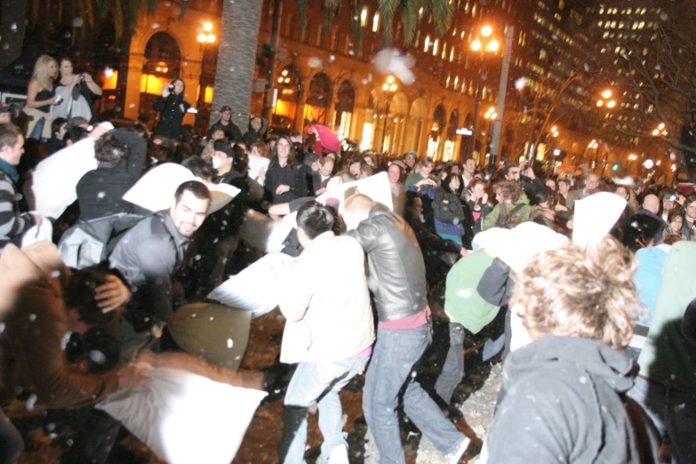 a crowd of people standing in the rain with umbrellas