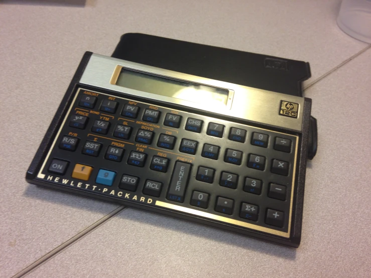 a calculator sitting on the counter top with a black case