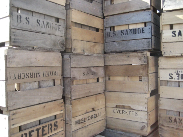 there is a lot of old wooden crates stacked up