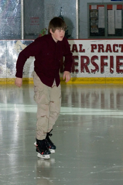 a boy wearing black ice skates on the ice
