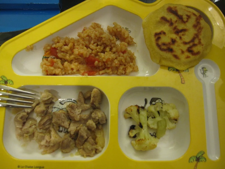 a yellow tray holding different types of food