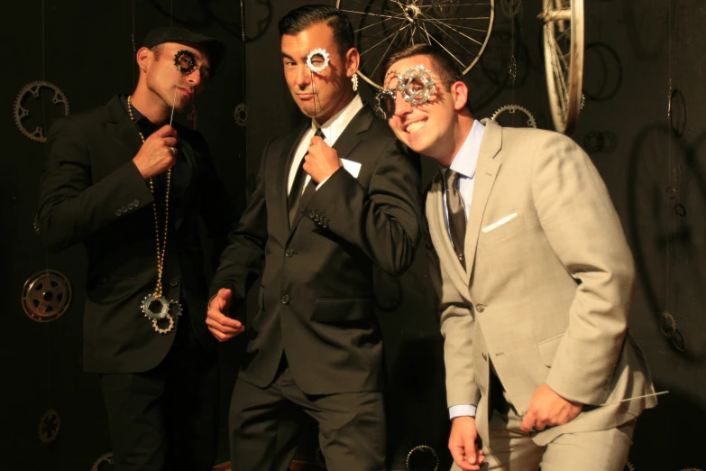 a group of men wearing suits and ties standing in front of a wall