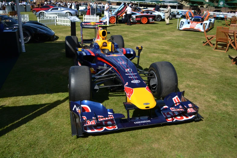 two red, blue and yellow race cars on display