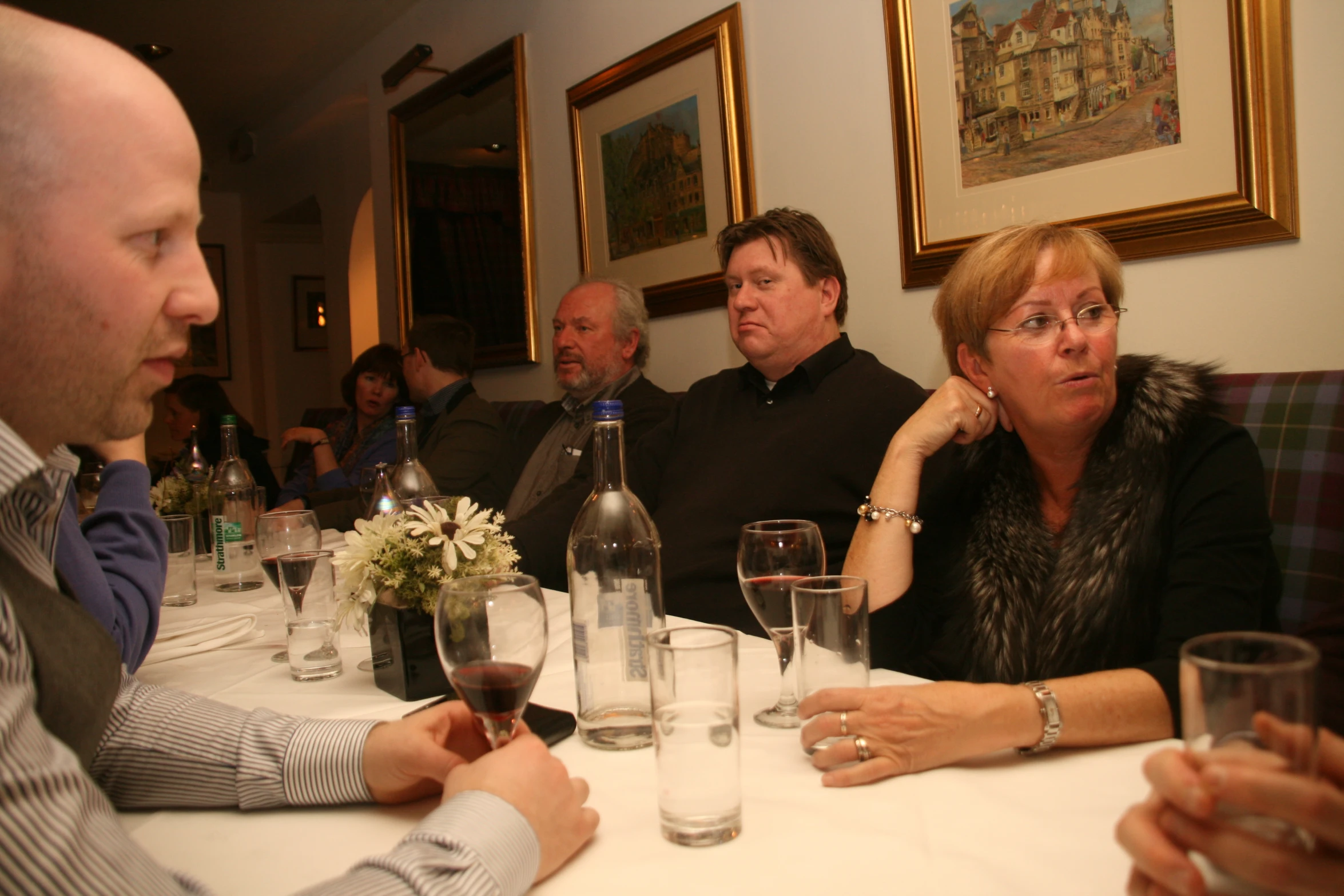 people sitting at a table drinking wine