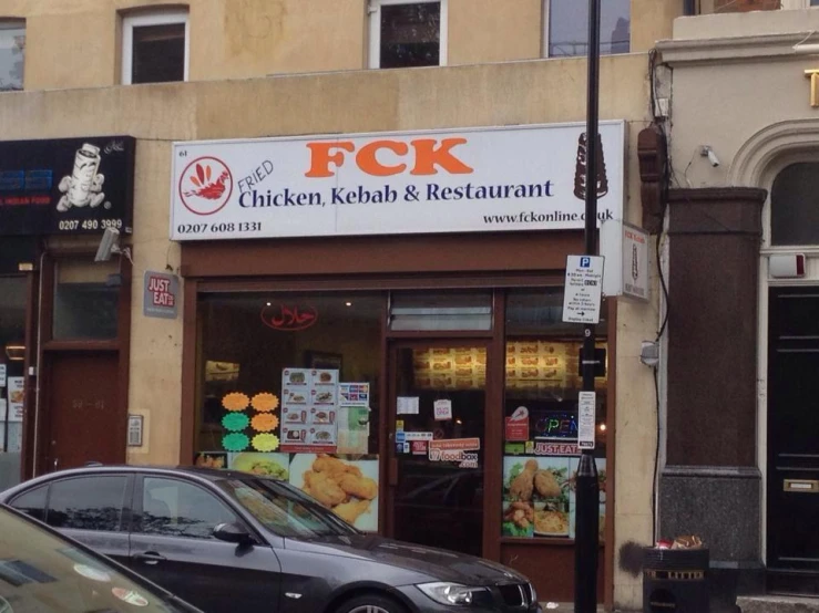 a small fast food restaurant with cars parked outside