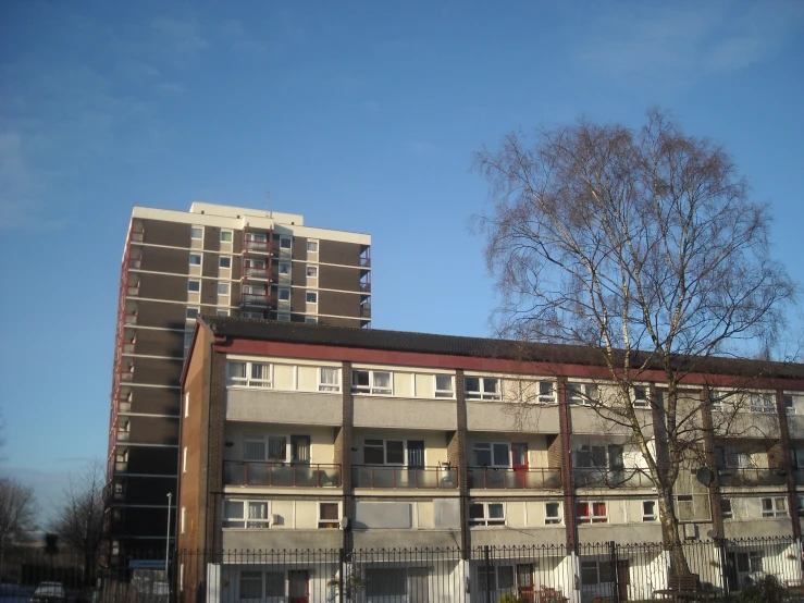 a tall building that has a fence surrounding it