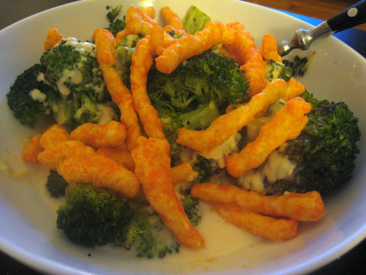 this is a meal of broccoli, cheetos, and cheese sticks