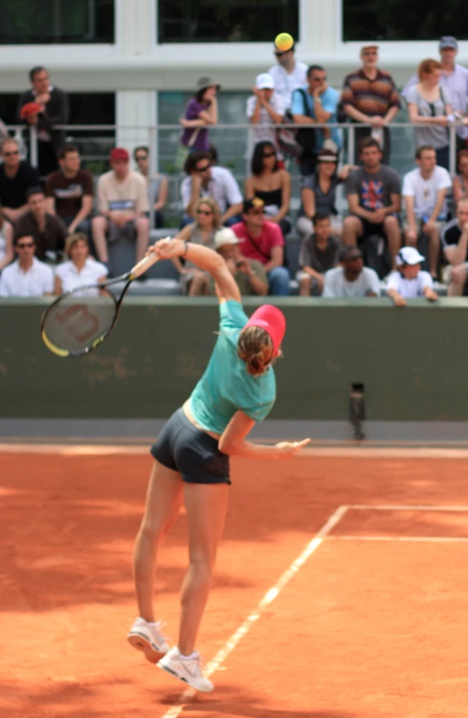 a tennis player is swinging her racquet