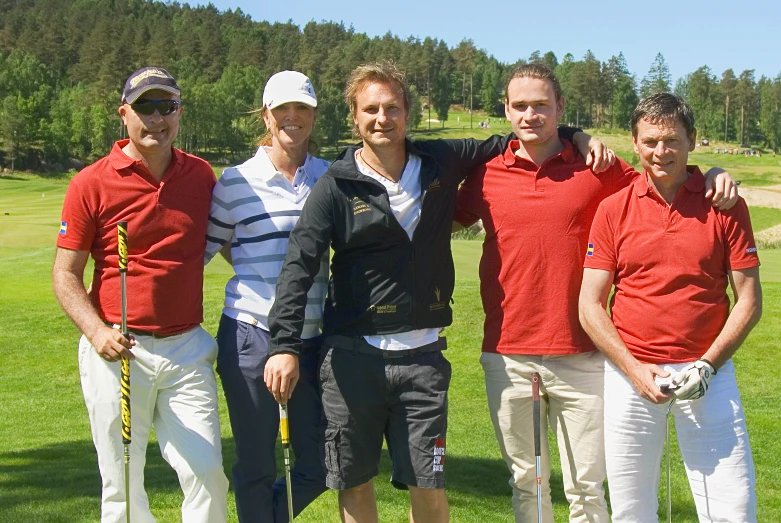 five men posing for a po on the golf course