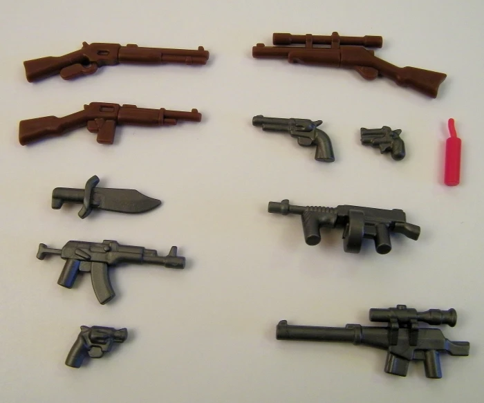 several lego guns are set on a table