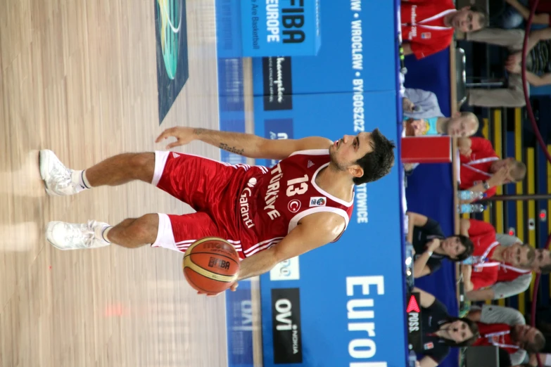 a basketball player dribbling the ball with one foot