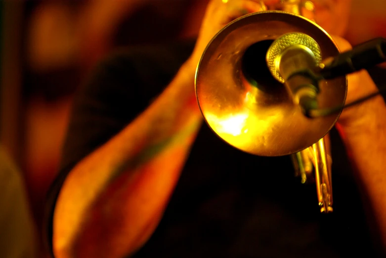 trumpet being played by musicians, with hand holding ss instrument