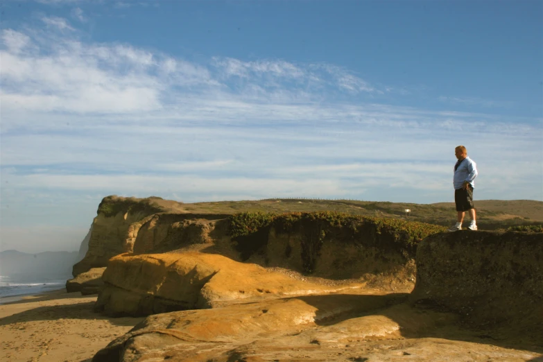 a person standing on top of a cliff overlooking a body of water