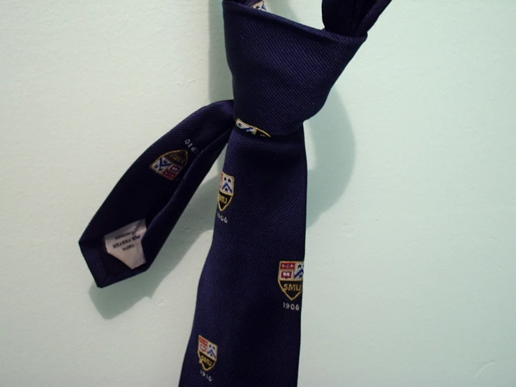 a navy tie with a tag hanging on it