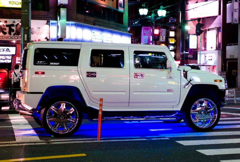 a big white vehicle driving on a city street