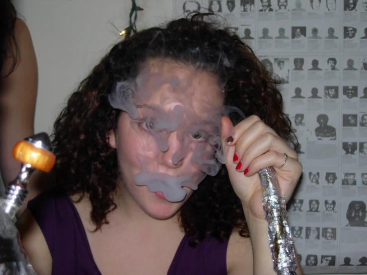 a woman with smoke on her face and head