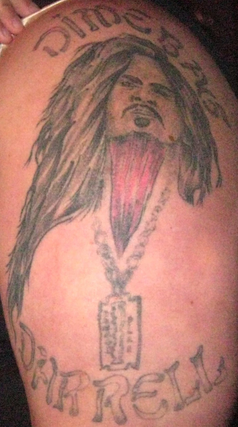 an ugly tattoo design of a man with a beard and dreadlocks