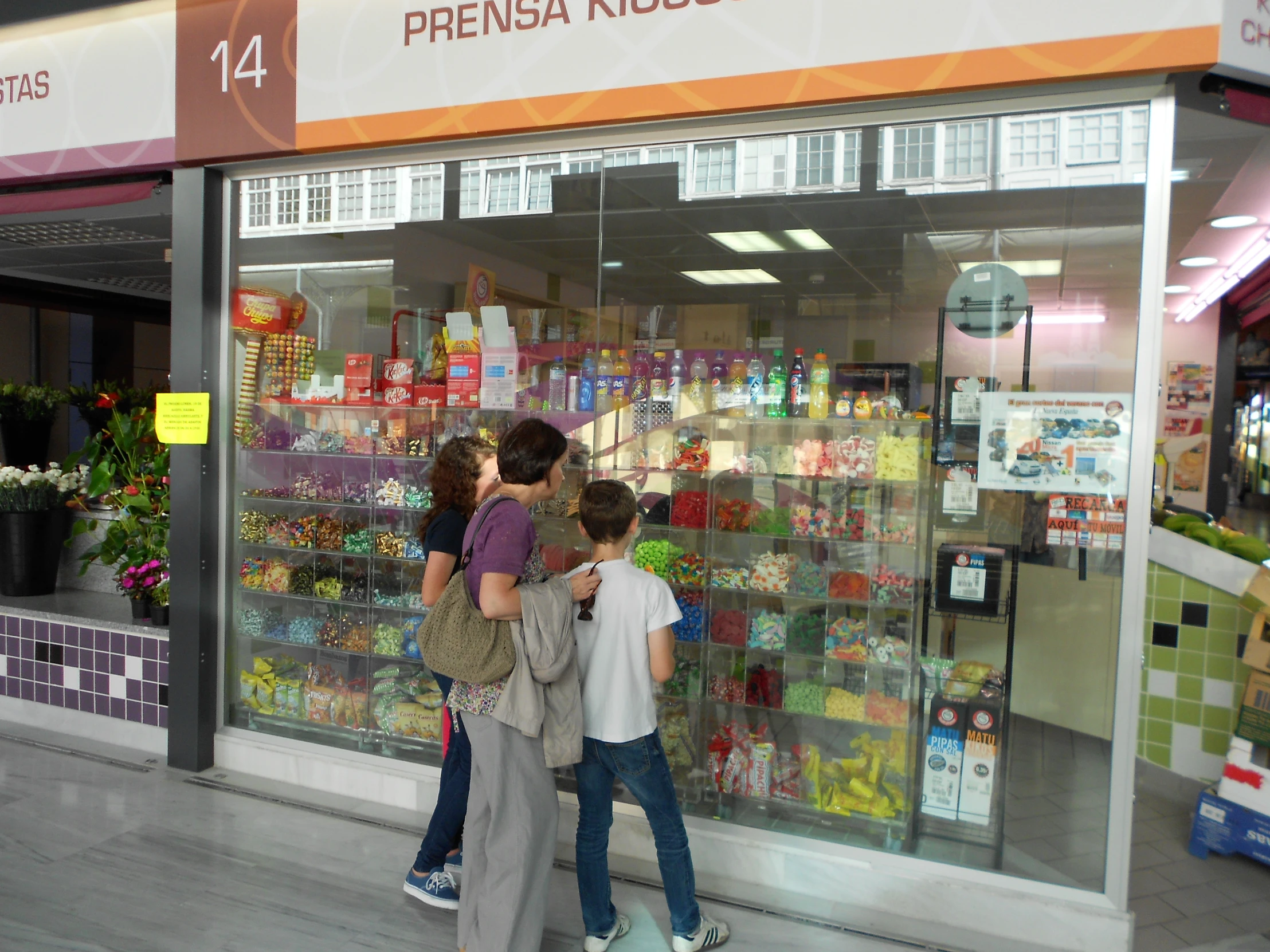 two girls are leaning up against a store