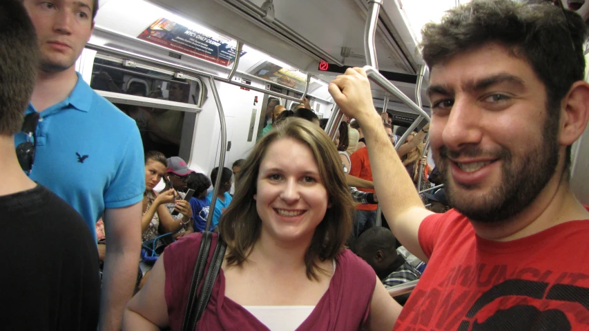 people are standing on a subway car in the city