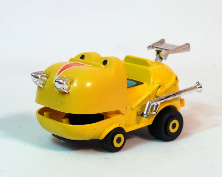 a yellow toy truck with a little engine