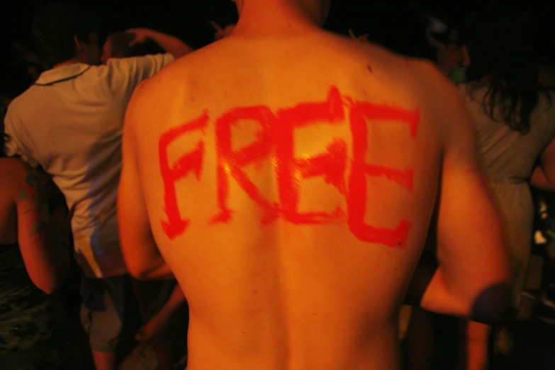 man with  has red spray paint on his back