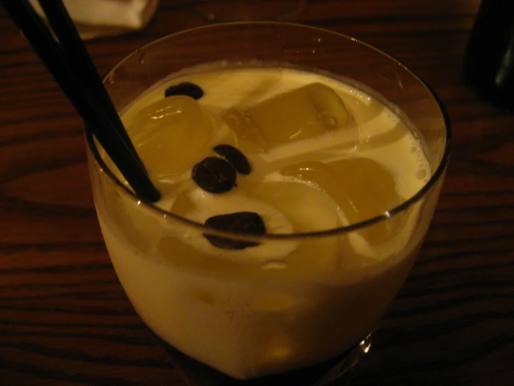 an alcoholic drink is garnished with ice and cherries