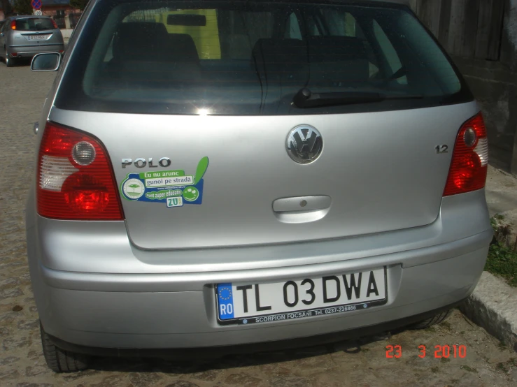 a silver vehicle with stickers on the back