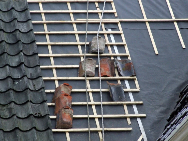 a pair of brick chimneys sit next to a roof of some sort